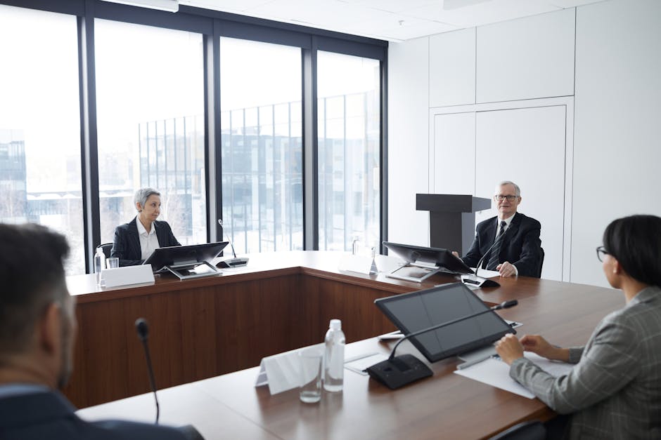 Business professionals in a board meeting in a modern conference room, engaging in discussion